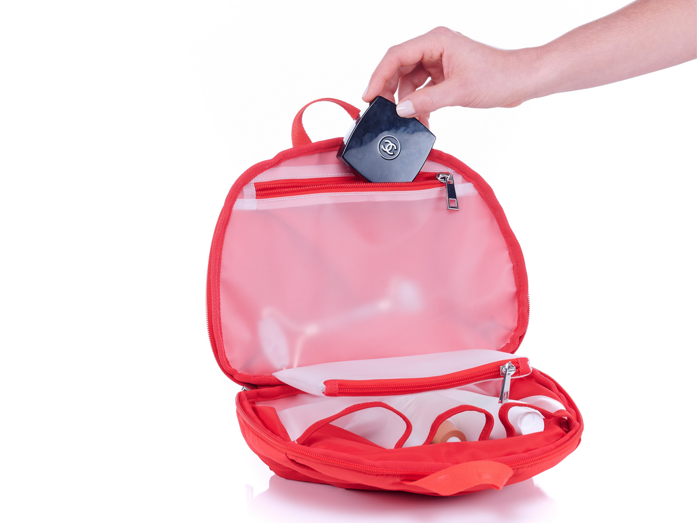 Toiletry Case interior view featuring back zip pocket and center zip pocket #color_cherry-red